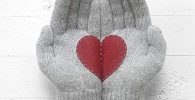 Grey gloves with red heart broken in two halves